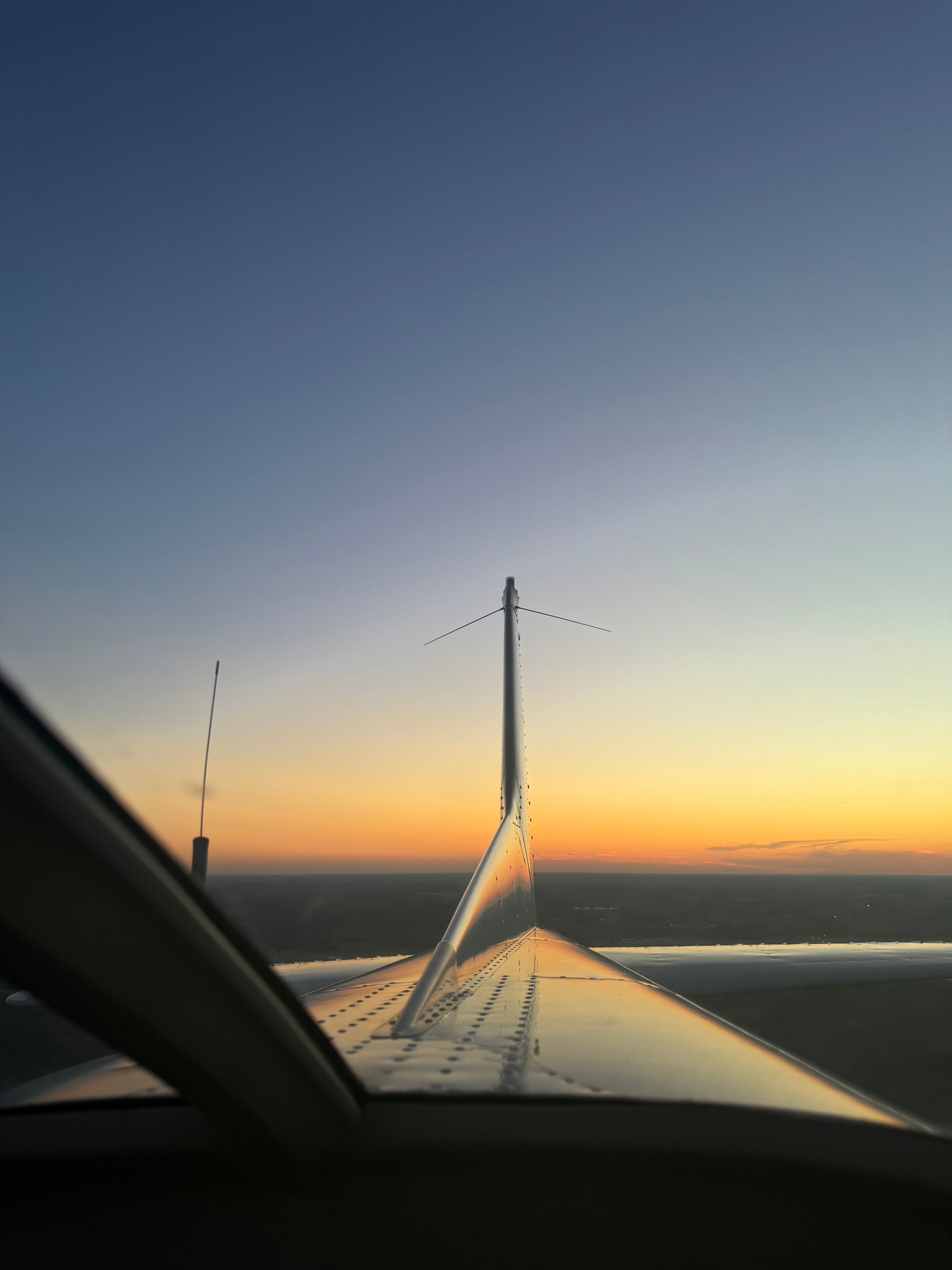 Airplane tail at sunset